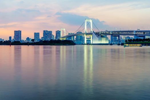 Sunset view of the city skyline and the Rainbow Bridge, in Tokyo, Japan