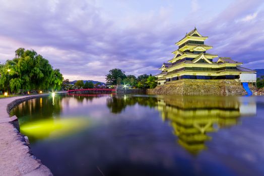 Night view of the Matsumoto Castle (or Crow Castle) and bridge, in Matsumoto, Japan