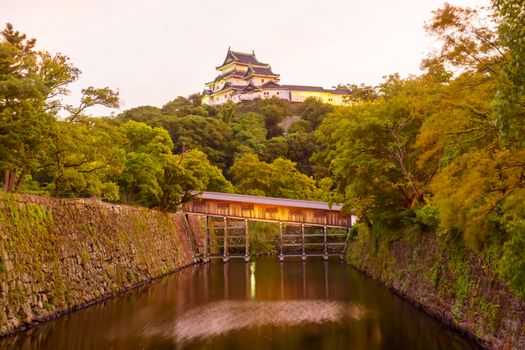 Sunset view of the Wakayama castle and the Ohashirouka Covered Bridge, in Wakayama City, Japan