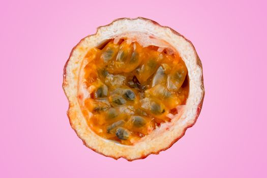 Maracuja cut in half and whole with leaf on pink background. Passion fruit yellow with fruit juice and seeds