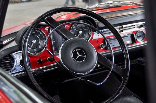 LONDON, UK - CIRCA SEPTEMBER 2011: Classic red Mercedes dashboard and steering wheel at Chelsea Autolegends car show.