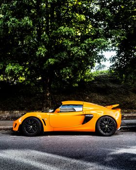 BAYONNE, FRANCE - CIRCA AUGUST 2020: An orange Lotus Exige S parked in the street.