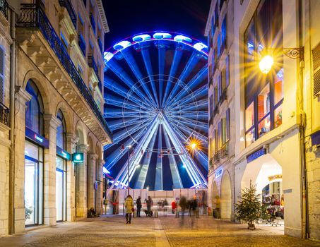 BAYONNE, FRANCE - DECEMBER 28, 2019: The ferris wheel as seen from rue Port Neuf at night.