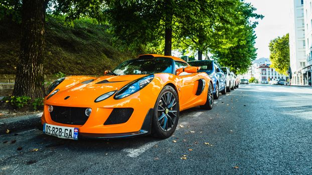 BAYONNE, FRANCE - CIRCA AUGUST 2020: An orange Lotus Exige S parked in the street.