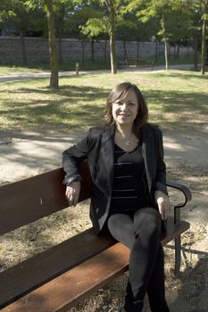 Mature woman in positive attitude sitting and standing