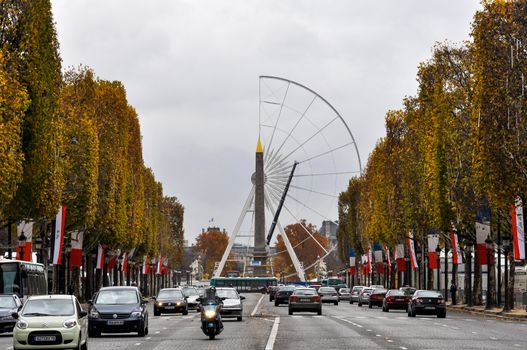 The Champs-Elysees and a ferris wheel under construction on Concorde Square in Paris, France