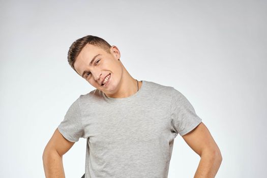 Handsome man in gray t-shirt cropped view of emotion Studio Model. High quality photo