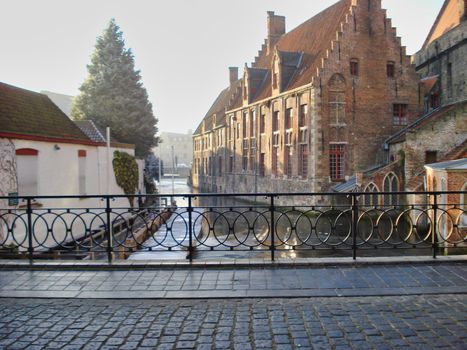 Bruges, Belgium, December 2007: View on a treelined canal in Bruges during winter, on a sunny day