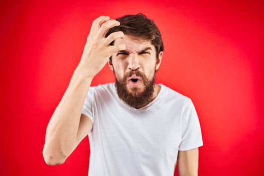 man in t-shirt gesturing with his hands dissatisfaction studio red uniform. High quality photo