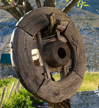 A wooden wheel hung on a tree in the old Bosnian village of Lukomir. Bjelasnica Mountain, Bosnia and Herzegovina.