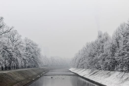 The Miljacka river in Sarajevo during the winter. In winter, Sarajevo has fog and pollution with little snow on the coast. Sarajevo, Bosnia and Herzegovina.