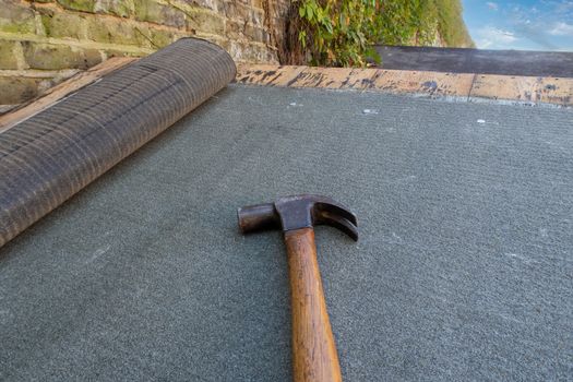 Shed or roof felt being fitted to a residential garden shed