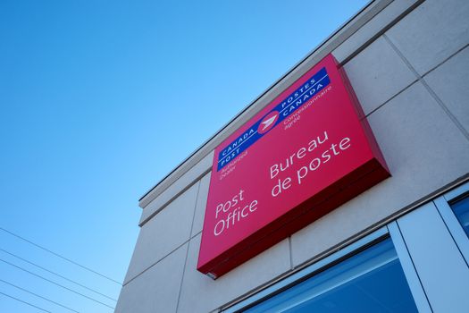Ottawa, Ontario, Canada - November 5, 2020: A Canada Post authorized dealer sign at a post office location in Barrhaven.