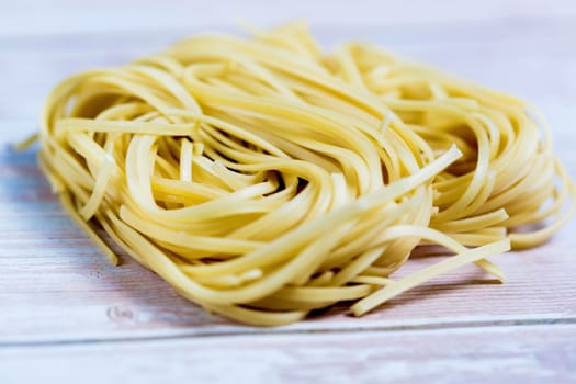 Closeup view of a Pile Of Uncooked Rolled Traditional Italian Pasta.