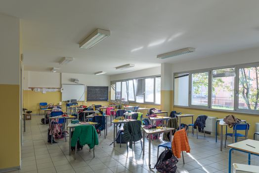 View of a classroom with desks and chairs, interior of a school