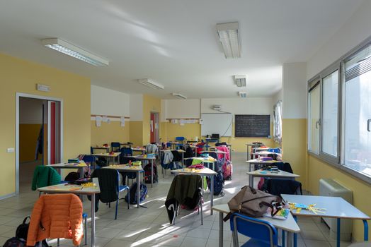 View of a classroom with desks and chairs, interior of a school