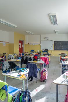 View of a classroom with desks and chairs, interior of a school