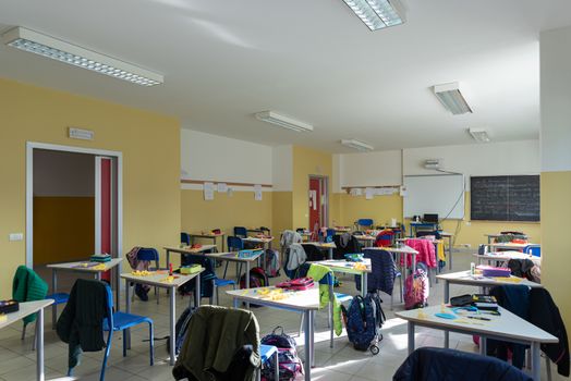 View of a classroom with desks and chairs, interior of a school