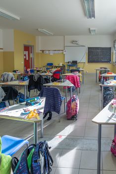 View of a classroom with desks and chairs, interior of a school