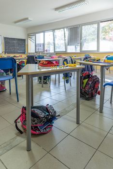 View of a classroom with desks and chairs, interior of a school