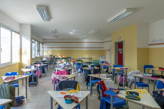 View of a classroom with desks and chairs, interior of a school