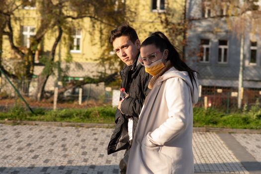 11/16/2020. Prague, Czech Republic. A couple is walking close to Hradcanska tram stop during quarantine (she is wearing a mask). This is a lockdown period in the Czech Republic due to the increase of COVID-19 infectious in the country. Hradcanska tram stop it is in Prague 6