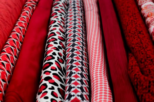 Detailed close up view on samples of cloth and fabrics in different colors found at a fabrics market.