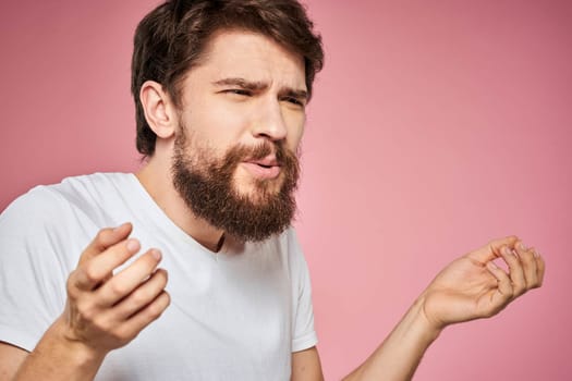 Man in white t-shirt emotions lifestyle facial expression cropped view pink background. High quality photo