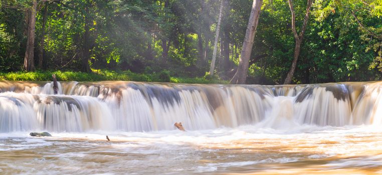 Water falls in tropical rainforest with rock and tree.  Namtok chet saonoi National Park in Thailand