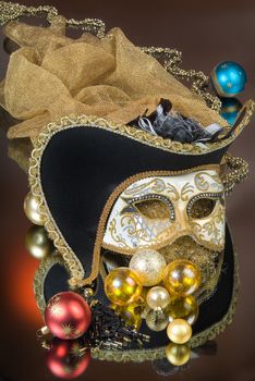 Mask and New Year balls on a glass studio background