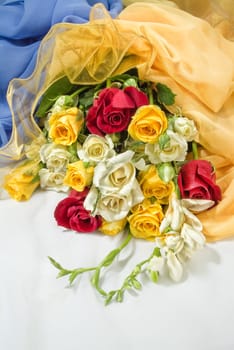 Still life with bouquet of flowers and accessories on a studio background