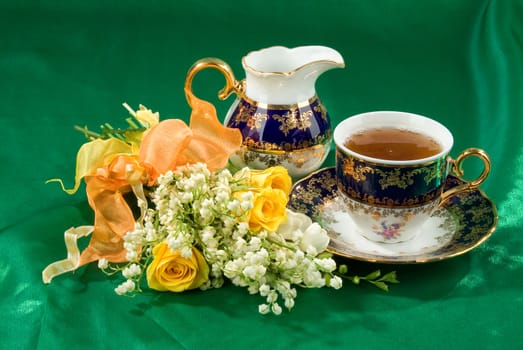 Still life with bouquet of flowers and accessories on a studio background