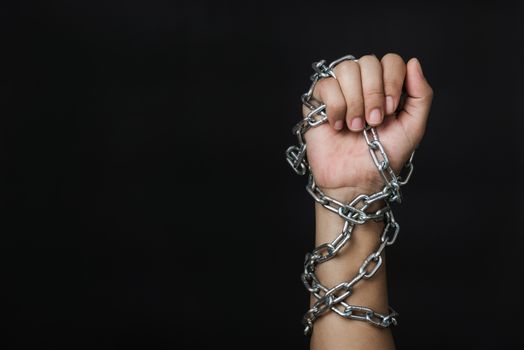 Woman chained on hand on black background, Human trafficking and abuse, International Human Rights day