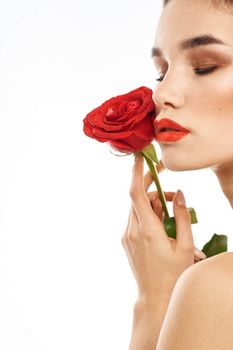 Portrait of woman with red rose naked shoulders Make-up on brunette face. High quality photo