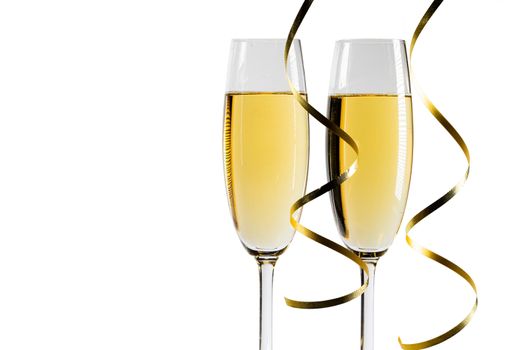 Pair glass of champagne and party curly ribbon. New year celebration or wedding concept. Studio isolated on white background