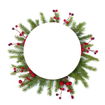 Christmas Border frame of tree branches and red berries on white background with copy space isolated