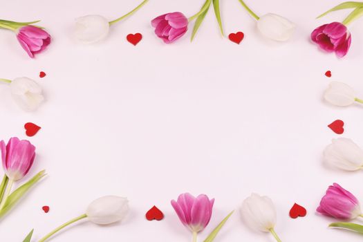 Frame made of colourful tulips and red hearts Valentines day background