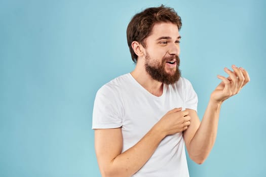 Cheerful man gesturing with his hands emotions cropped view on blue background studio. High quality photo