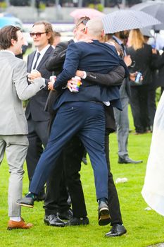 MELBOURNE, AUSTRALIA - NOVEMBER 2: Drunk punters at the end of Derby Day at the 2019 Melbourne Cup Carnival at Flemington Racecourse in Melbourne Australia