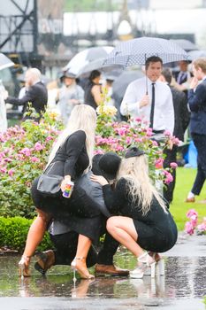 MELBOURNE, AUSTRALIA - NOVEMBER 2: Drunk punters at the end of Derby Day at the 2019 Melbourne Cup Carnival at Flemington Racecourse in Melbourne Australia