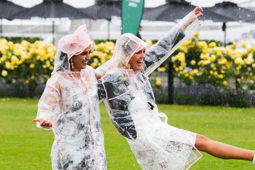 MELBOURNE, AUSTRALIA - NOVEMBER 6: Guests braving the rain on Lexus Melbourne Cup Day at the 2018 Melbourne Cup Carnival