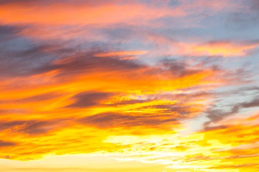 Dramatic yellow and orange colored sunset cloudscape for background or sky replacement photo editing. Beauty in nature