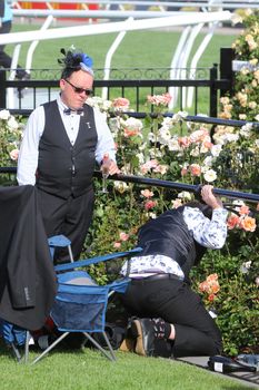 MELBOURNE, AUSTRALIA - NOVEMBER 05, 2019: Drunnk punters at the end of the Lexus Melbourne Cup Day at the 2019 Melbourne Cup Carnival at Flemington Racecourse in Melbourne Australia