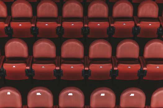 empty red chairs in the outdoor arena.