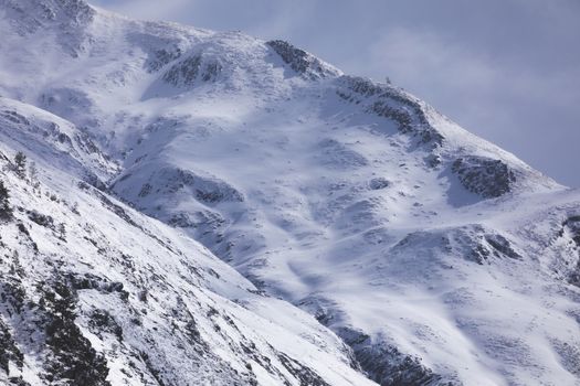 Snowy mountains landscape in the Aragonese Pyrenees. Aguas Tuertas valley, Hecho and Anso, Huesca, Spain.