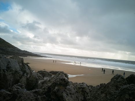 Looking down on Caswell Beach from the rock formations to the rear of the Bay on a cloudy and Autumns day.