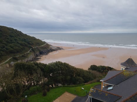 Overlooking the Sea from the cliffs above Caswell Bay, Gower, Wales, UK in Autumn. Stunning coastal vies with cloudy skies.