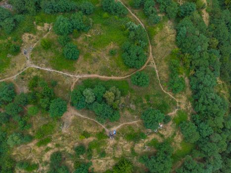 Top down aerial look to paths in park on hill