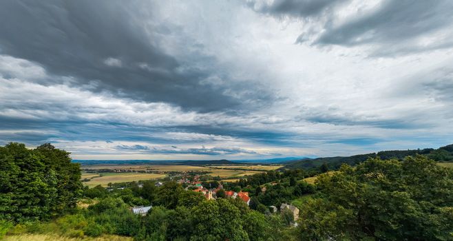 Panoramic view of small village in mountains and fields