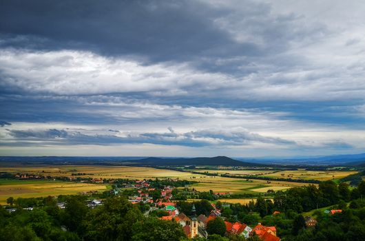 Look to small village in mountains and a lot of fields